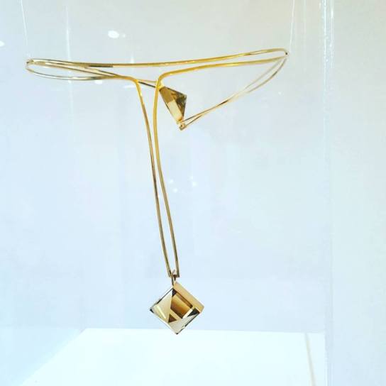 A golden necklace with two smoky quartz, designed by Paula Häiväoja. A golden necklace with two smoky quartz, designed by Paula Häiväoja.